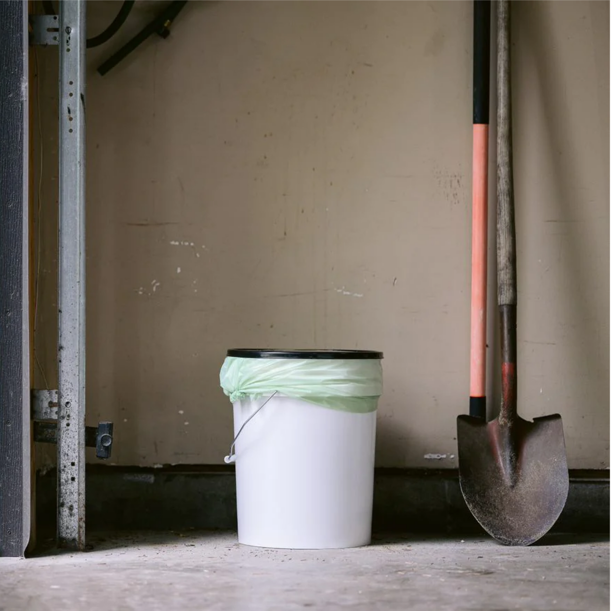 bucket with compostable bag in a garage