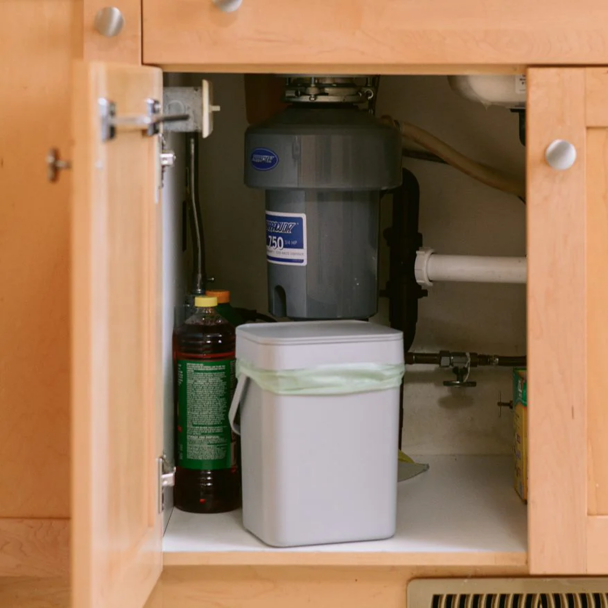 bin with compostable bag in a cabinet under the sink