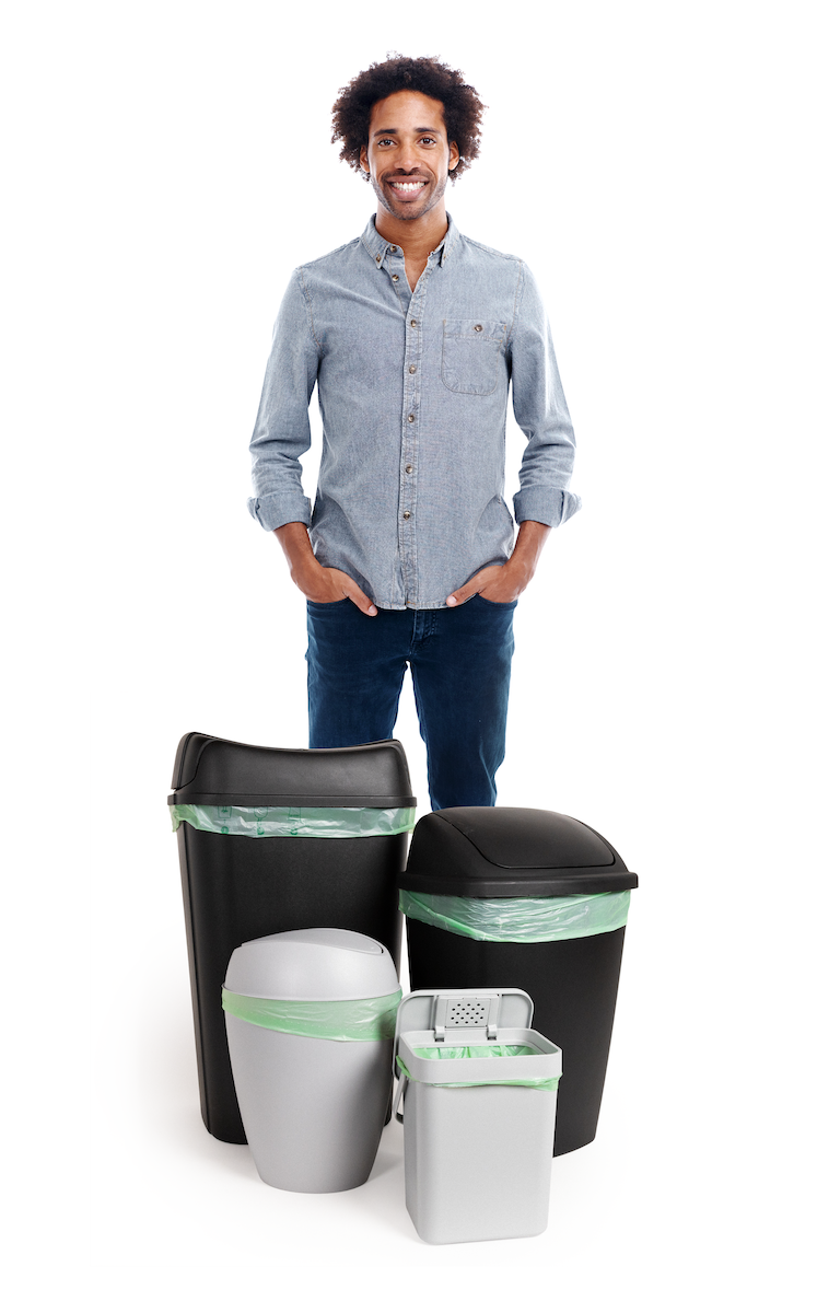 someone standing next to bins with the compost bag; the bin comes up past the person's knee