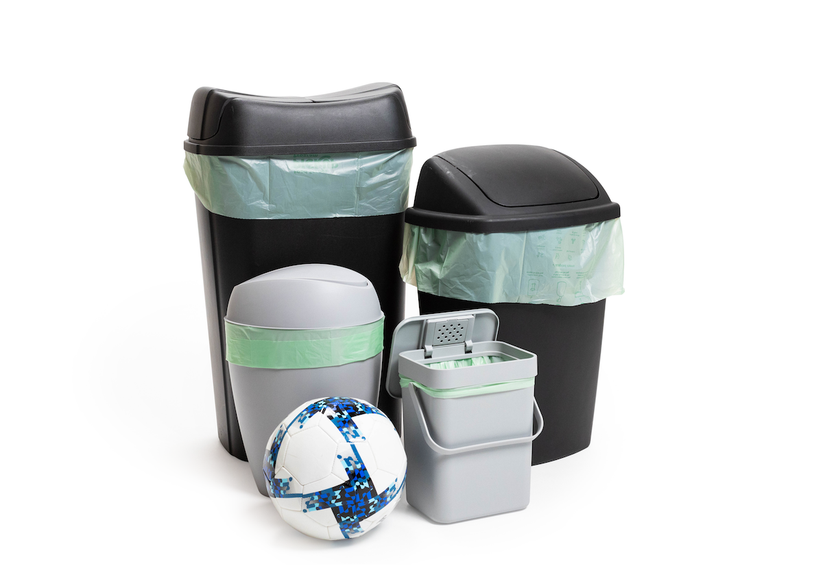 bins with the compost bag next to a soccer ball; the bag is a little larger than the ball